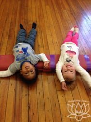 Little family yoga toddlers on a mat