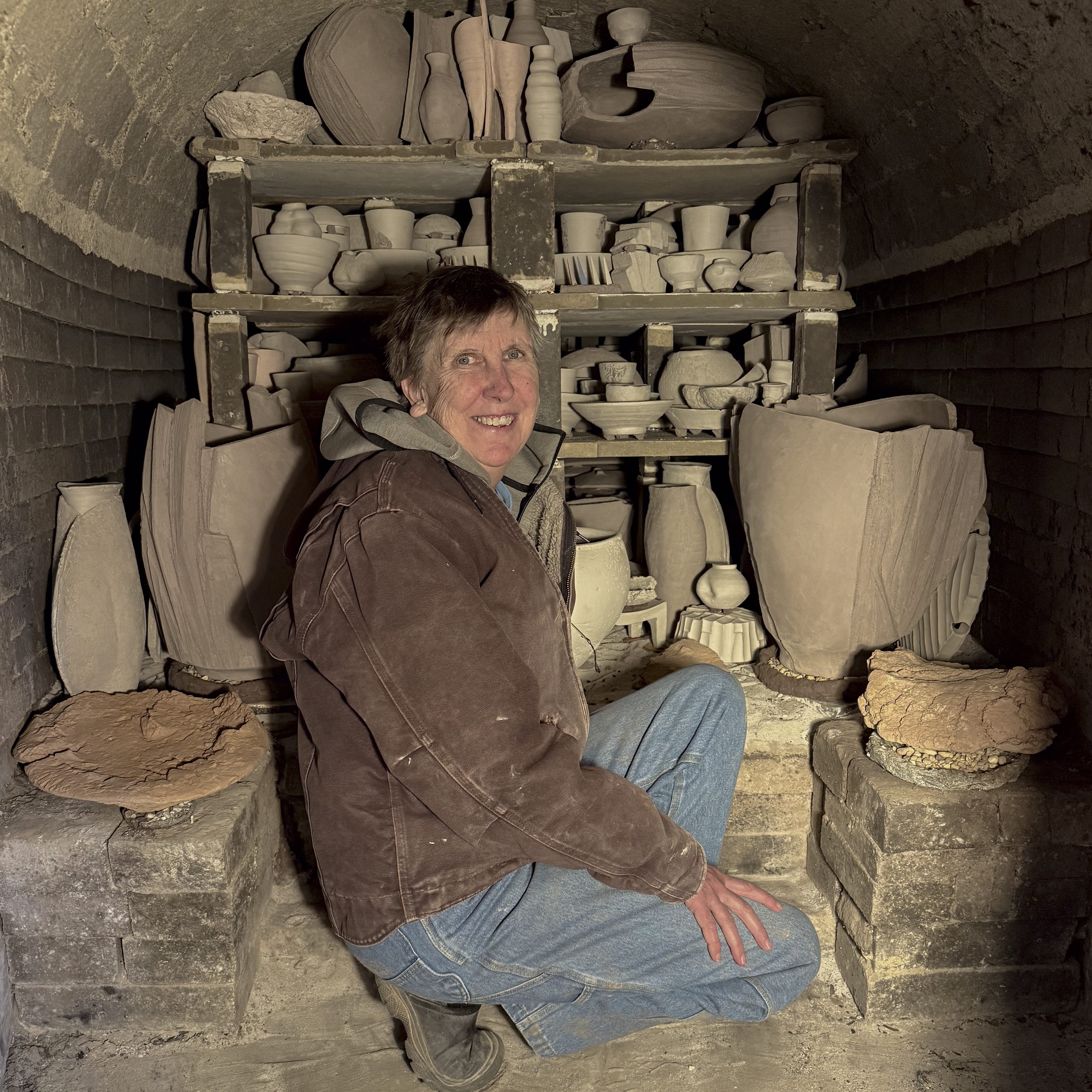 Catherine stacking the anagama Catherine White