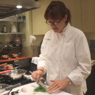 Chef Wendi James preps vegetables in Hill Center's kitchen